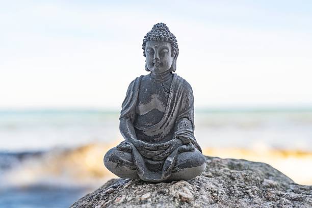 istock Buddha Statue on the Beach, tranquil scene, mindfulness and balance concept 2241379739