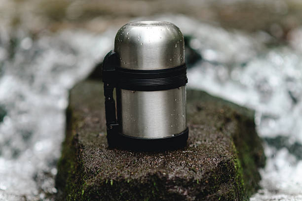 istock small thermos with tea for travellers stands in river 2241382815