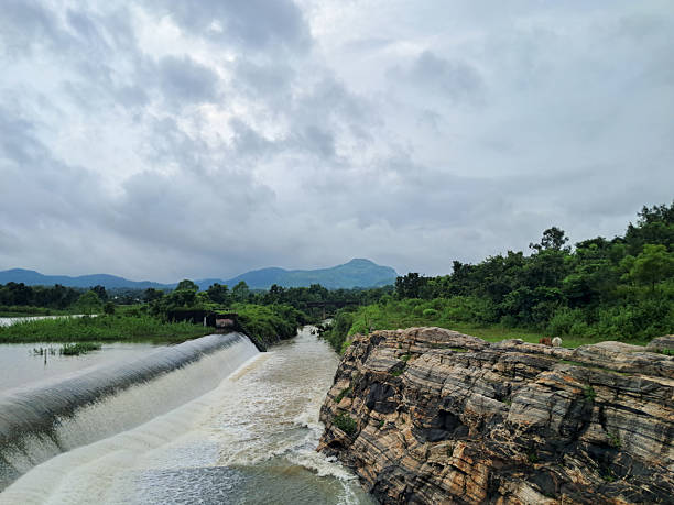 istock Dam Spillway and Waterfall Flowing into Reservoir Under Dramatic Cloudy Sky. 2241383143
