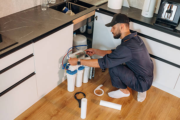 istock Plumber working in the kitchen under the sink 2241384522