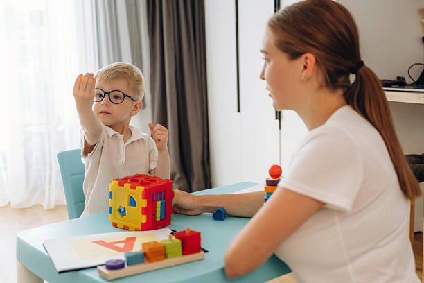 istock Speech therapist is with young boy indoors 2241384819