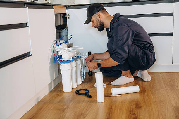 istock Installing new filters. Plumber working in the kitchen under the sink 2241385726