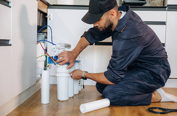 istock Changing filters. Plumber working in the kitchen under the sink 2241385735