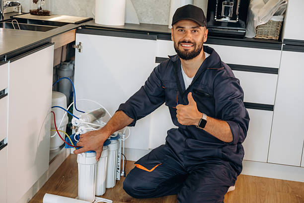 istock Changing filters. Plumber working in the kitchen under the sink 2241385737