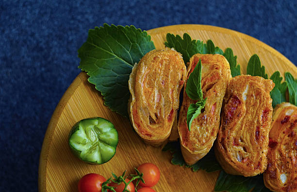 there are small tomatoes and pita bread on the board