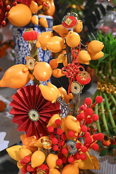 Lemon and red berry flower arrangements in clay pots on an orange tablecloth