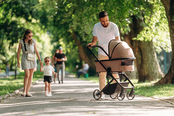 istock Having a good walk. Couple is with daughter and cradle 2241387335