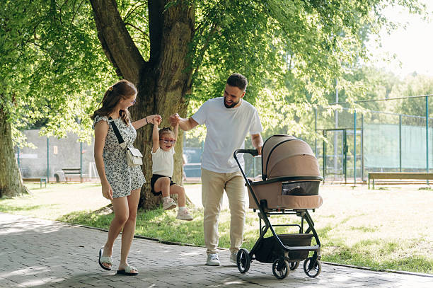 istock Having a good walk. Couple is with daughter and cradle 2241387746