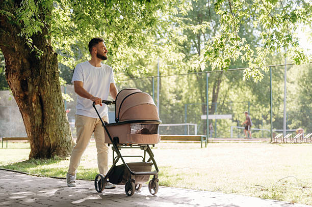 istock Father is with cradle, having a walk in the park 2241387752
