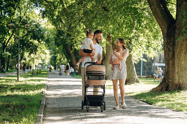 istock Couple is with daughter and cradle are having a walk 2241388126