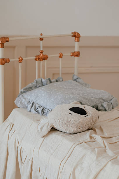istock Cozy Bed with Teddy Bear and Ruffled Pillow 2241389617