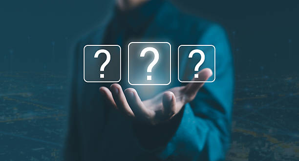 istock Businessman holding virtual question mark icons, symbolizing uncertainty, decision-making, problem-solving, and business strategy in digital technology and innovation for corporate planning. 2241390484