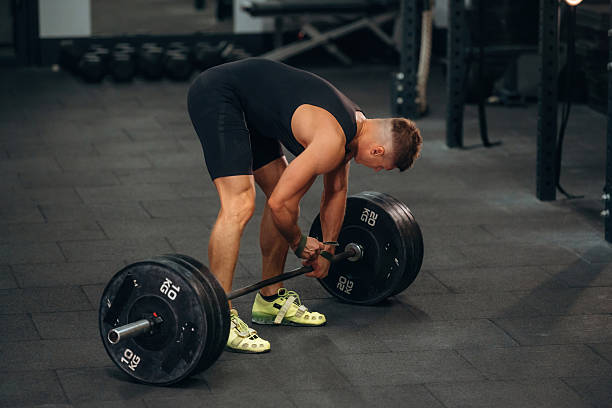 istock Getting ready. Athletic man performing weightlifting exercises with a barbell in a gym 2241391191