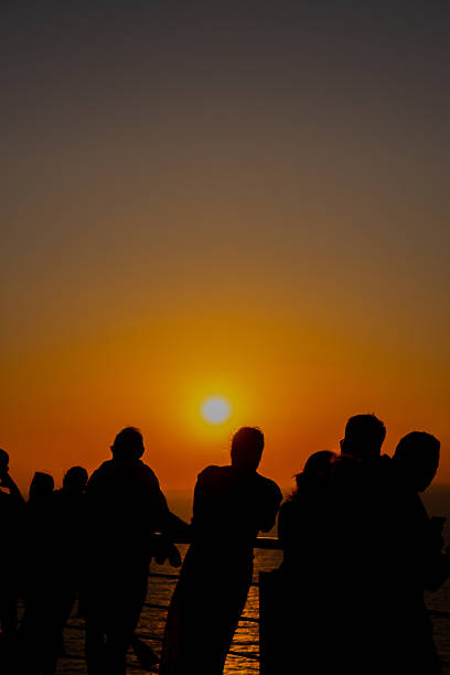 istock People Looking at Orange Sunset. 2241394491