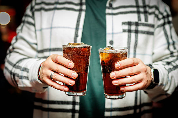 istock Person holding two cola drinks in glasses with ice 2241395940
