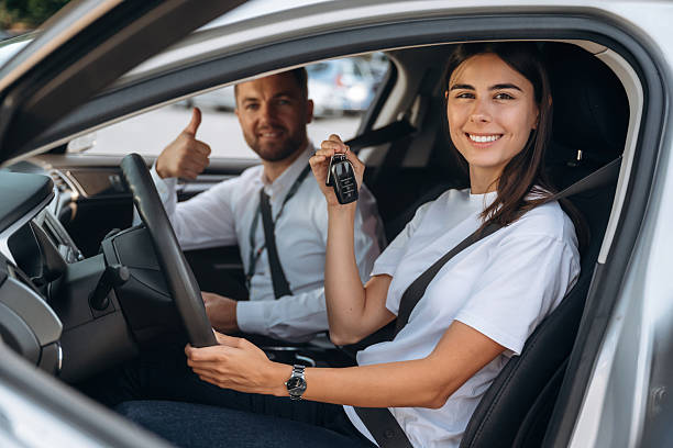 istock Woman is with instructor in car, driving school concept 2241397109