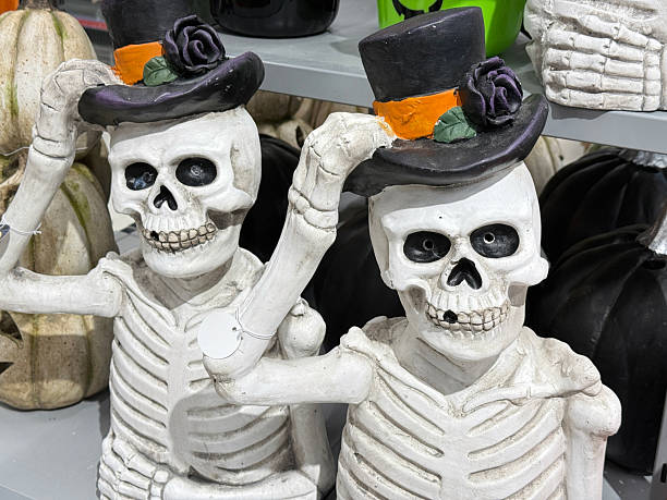 istock Halloween Decorations with Two Scary Skeleton Figures Wearing Hats 2241398809