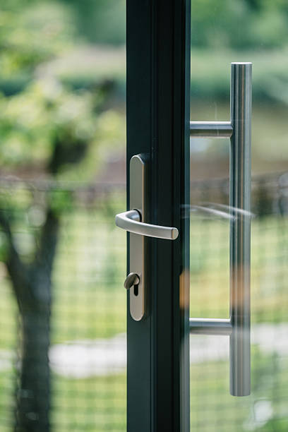 istock Modern front door with transparent glass and sleek handle in residential setting 2241398964