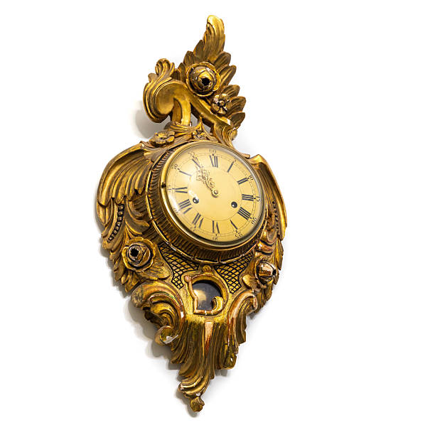 istock Vintage gilded clock isolated on white background featuring intricate floral carvings 2241400445