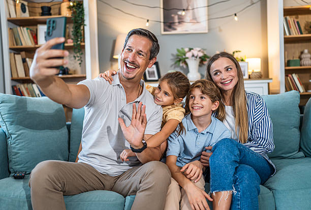 istock Family doing video call from couch at home 2241400834