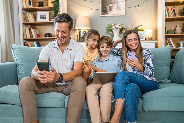 istock Family enjoying technology couch time together at home 2241401278
