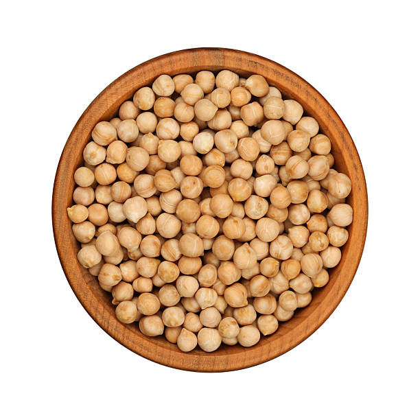 istock Chickpeas in wooden bowl from top view on white background 2241402049