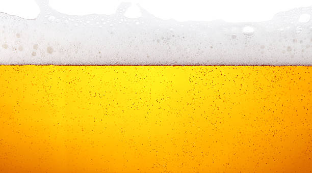 istock Refreshing golden beer bubbling with foamy head 2241402191