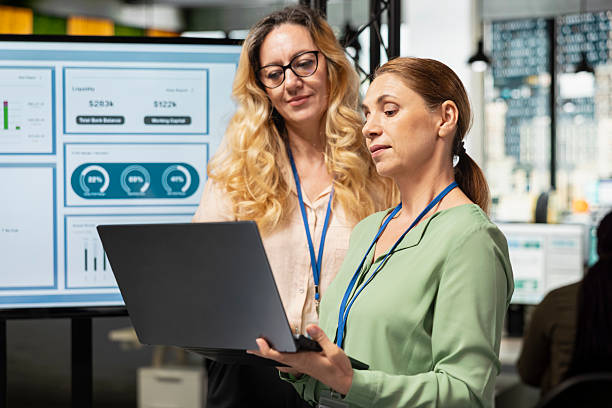 istock Professional coworkers fixing a strategy and exchanging reports 2241403118
