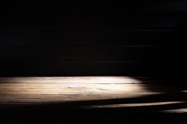 istock Old brown wooden floor or empty table with light coming from behind on a black and dark background. 2241403918