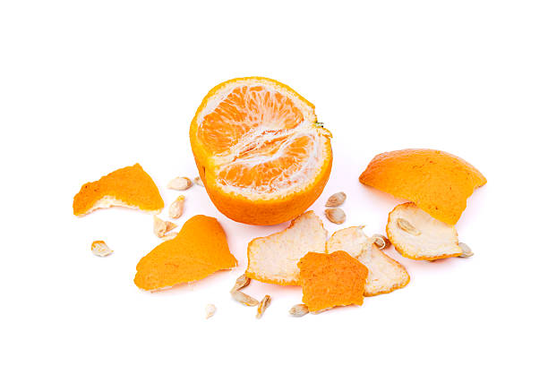 Orange with peel and seeds separated on white background - top view