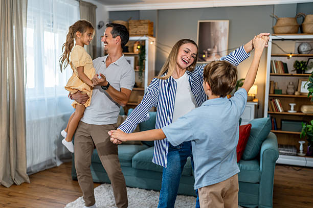 istock Happy family dancing together at home 2241403988