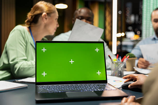 istock Workers group reviewing insights with chroma key after hours 2241404386