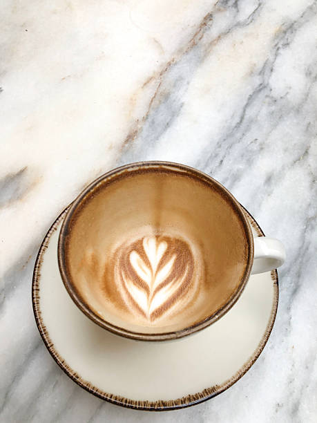 istock Empty coffee cup with remaining latte art foam on marble table after finished drink 2241404510