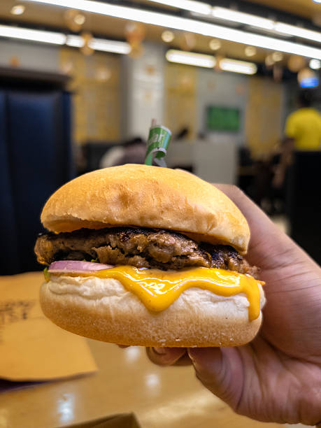 Fast Food Photography: Hand Holding a High-Quality Burger