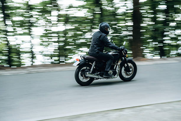 istock Driving fast. Man in leather clothes on motorcycle is on the road 2241405231