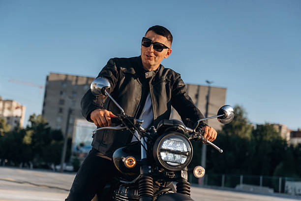 istock In cool sunglasses. Man is outdoors with his motorcycle 2241405841