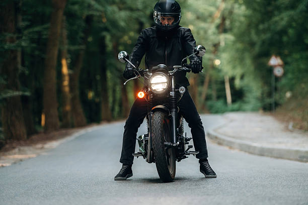 istock Front view. Man in leather clothes on motorcycle is on the road 2241405842