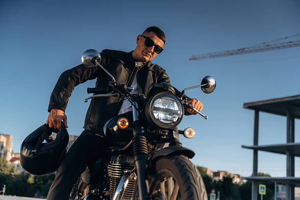 istock Against clear sky, in sunglasses. Man is outdoors with his motorcycle 2241405918