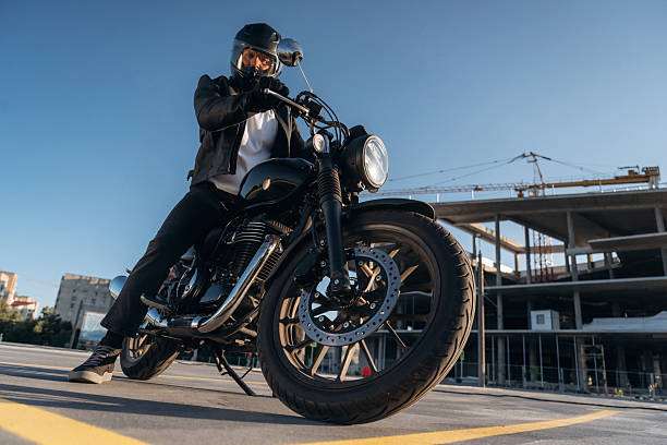 istock Unrecognizable in the protective hat. Man is outdoors with his motorcycle 2241405925