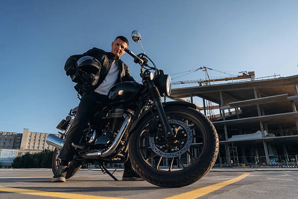 istock Bright sunlight, parked. Man is outdoors with his motorcycle 2241405962