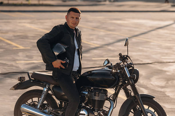 istock Under beautiful sunlight. Man is outdoors with his motorcycle 2241406071