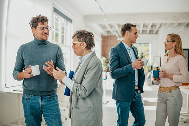 istock Professionals engage in lively discussion while collaborating in a modern office space 2241408634