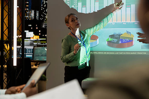 istock General director showing statistics data on projection board in a conference 2241411852