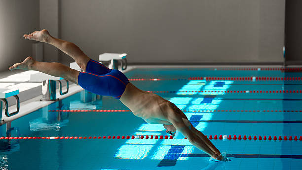 istock Swimmer entering water with powerful streamlined body position at start 2241412957