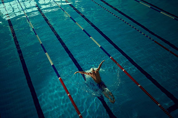 Big image of young girl, swimmer in red swimsuit and swimming gap standing by small swimming pool. Creative collage. Concept of professional sport, competition, tournament, game. 3D render.