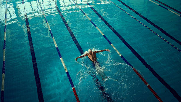 istock Focused swimmer executing butterfly stroke in indoor lane with powerful energy 2241412967