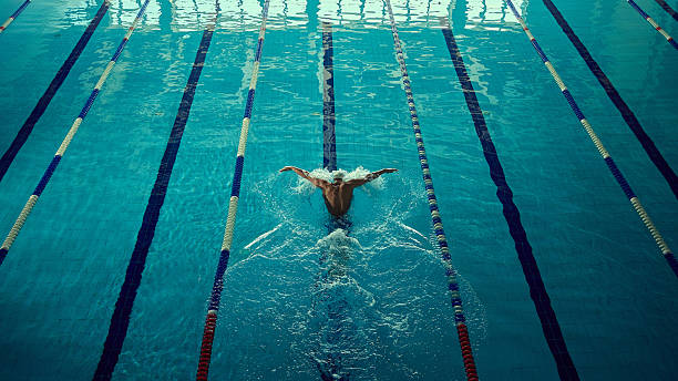 istock Professional swimmer in butterfly stroke captured mid-motion with inspiring power 2241412977