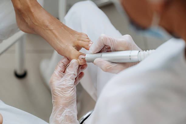 istock Cleaning the nail. Podiatrist with client in clinic 2241413403