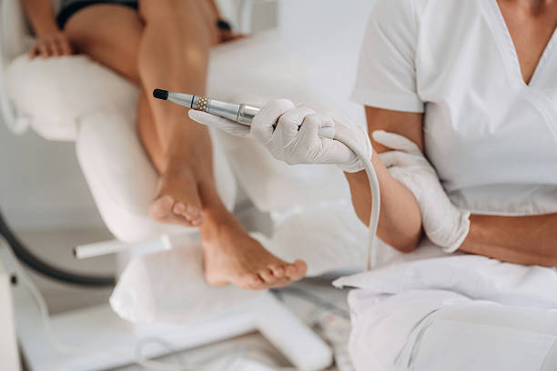 istock Silver professional peeling equipment. Podiatrist with client in clinic 2241413589