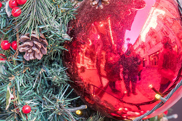 istock Red Christmas ornament on decorated pine tree 2241417360